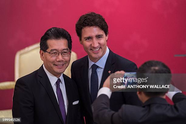 Canadian Prime Minister Justin Trudeau poses for a photo with Secretary for Commerce and Economic Development of Hong Kong Greg So , during a...