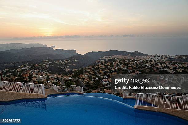 Burned fields are seen behind a residencial area after a wildfire on the coastline on September 6, 2016 in Benitachell, near Javea, in Valencia...