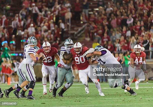 Joey Alfieri and Solomon Thomas of the Stanford Cardinal rush quarterback Jesse Ertz of the Kansas State Wildcats during an NCAA football game played...