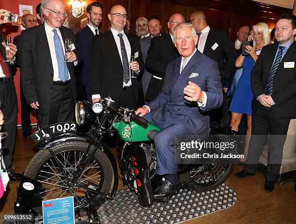 Prince Charles, Prince of Wales tries a 1933 BSA 500cc motorbike used for delivering telegrams as he attends a reception to mark the 500th...