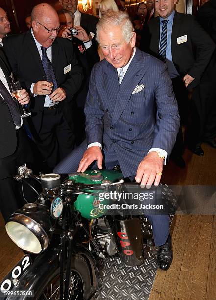 Prince Charles, Prince of Wales tries a 1933 BSA 500cc motorbike used for delivering telegrams as he attends a reception to mark the 500th...