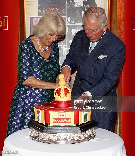 Prince Charles, Prince of Wales and Camilla, Duchess of Cornwall cut into a celebratory Royal Mail 500 Cake as they attend a reception to mark the...