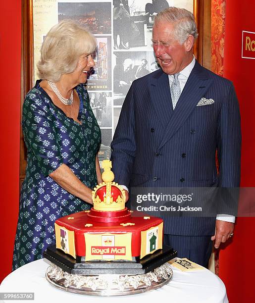 Prince Charles, Prince of Wales and Camilla, Duchess of Cornwall cut into a celebratory Royal Mail 500 Cake as they attend a reception to mark the...