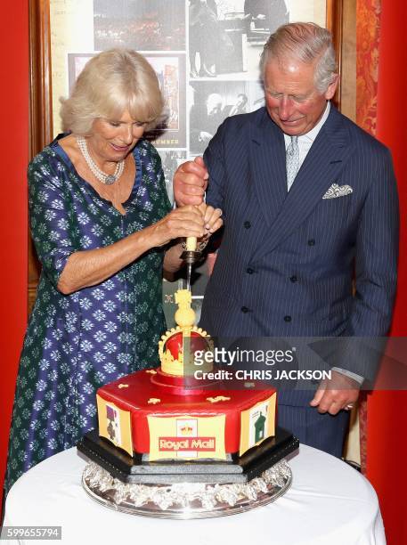 Britain's Prince Charles, Prince of Wales and his wife Britain's Camilla, Duchess of Cornwall, react as they cut into a celeratory cake during a...