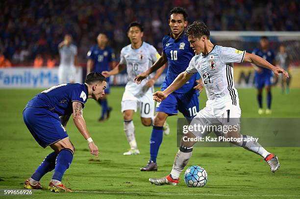 Gotoku Sakai of Japan competes for ball against Tristan Do and Teerasil Dangda of Thailand during the 2018 FIFA World Cup Qualifier between Thailand...