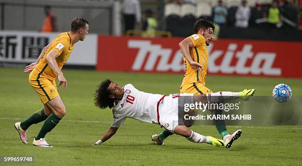 S midfielder Omar Abdulrahman vies with Australia's Mathew Leckie and Brad Smith during their World Cup 2018 Asia qualifying football match United...