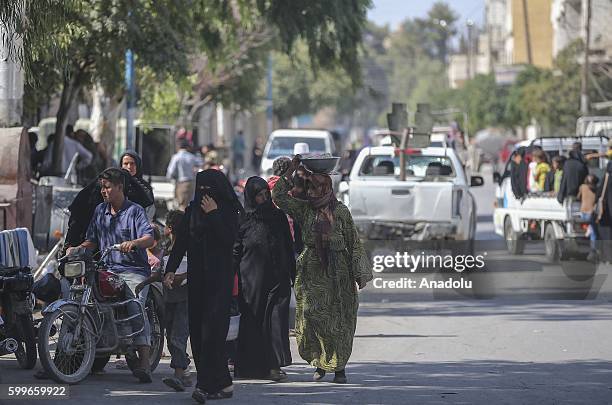 Syrians wait with their buckets as The Foundation for Human Rights and Freedoms And Humanitarian Relief gives hot meal at Martyrs Square as the...