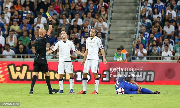 Giorgio Chiellini of Italy receives his first yellow card during the World Cup 2018 qualifier football match Israel vs Italy at Sammy Ofer Stadium in...