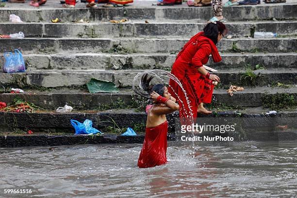 Nepalese Hindu women perform ritual bath in the Bagmati River during the Rishi Panchami festival in Kathmandu, Nepal, September 6, 2016. Rishi...