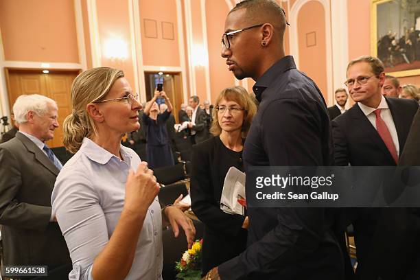 Bayern Munich football star Jerome Boateng chats briefly with his mother Martina Boateng after he received the 2016 Moses Mendelssohn Award as Berlin...