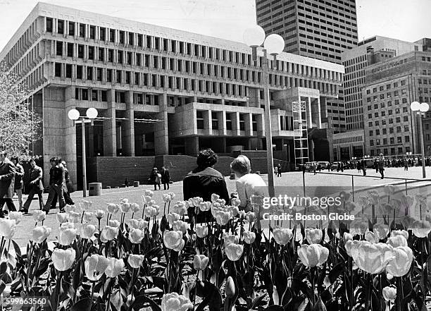 People sit in City Hall Plaza in Boston on May 6, 1975.