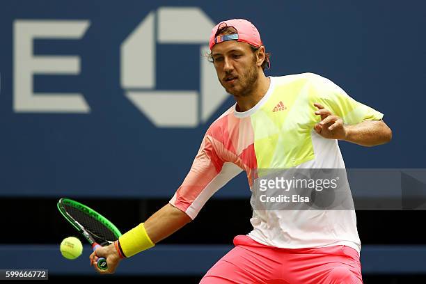 Lucas Pouille of France returns a shot to Gael Monfils of France during their Men's Singles Quarterfinal Match on Day Nine of the 2016 US Open at the...