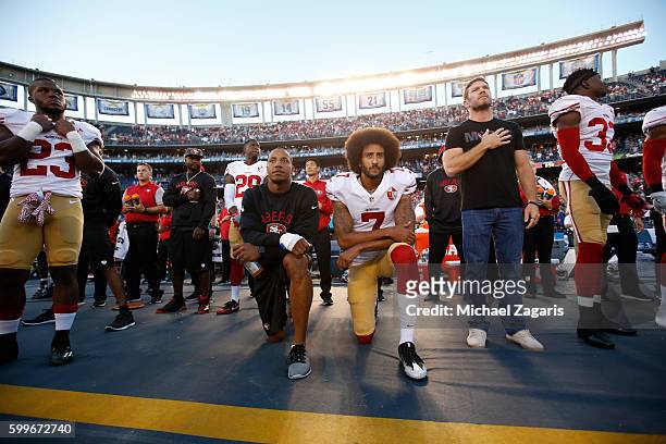 Eric Reid and Colin Kaepernick of the San Francisco 49ers kneel on the sideline during the anthem, as free agent Nate Boyer stands, prior to the game...