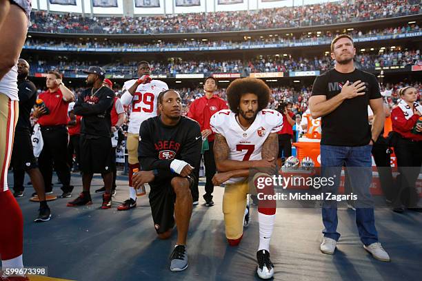 Eric Reid and Colin Kaepernick of the San Francisco 49ers kneel on the sideline during the anthem, as free agent Nate Boyer stands, prior to the game...