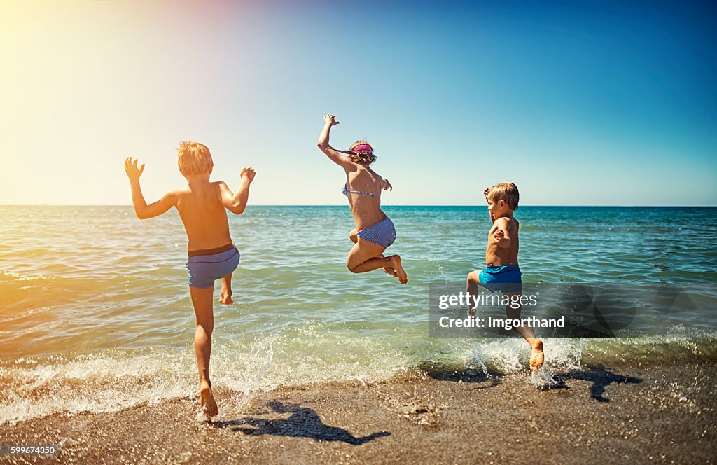 Summer vacations in Italy - kids jumping into the sea