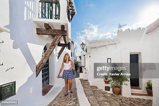 teenage girl walking in the streets of binibequer vell - minorca stock pictures, royalty-free photos & images