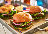 patriotic american cheese burges with flags on tray