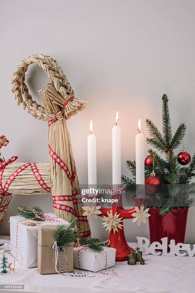 Christmas decorations and wrapped gifts in candle light