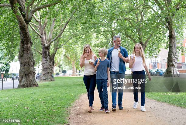 happy family eating ice cream at the park - teenagers eating with mum stock pictures, royalty-free photos & images