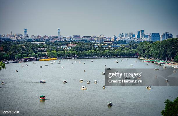 tourists cruising in man-powered boats, beihai park, beijing - beihai park stockfoto's en -beelden