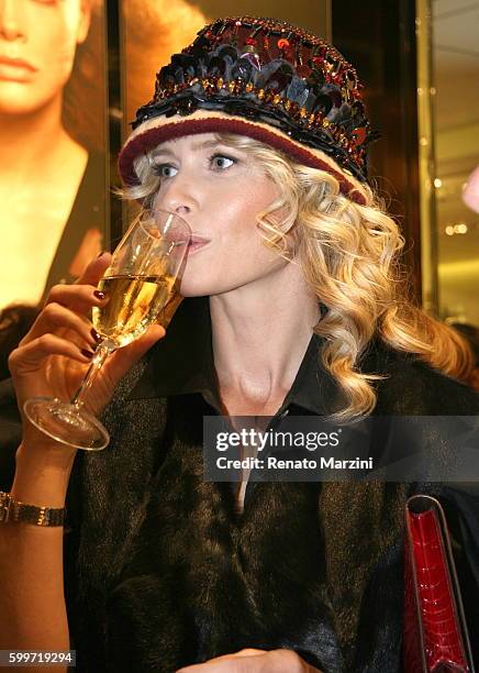 Daniela Pestova drinks a glass champagne at the Prada boutique opening on September 16, 2009 in Prague, Czech Republic