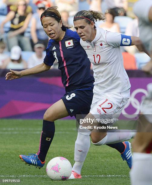 England - Japan's Azusa Iwashimizu vies for the ball with a Canadian player during the second half of an Olympic women's soccer Group F opener at the...