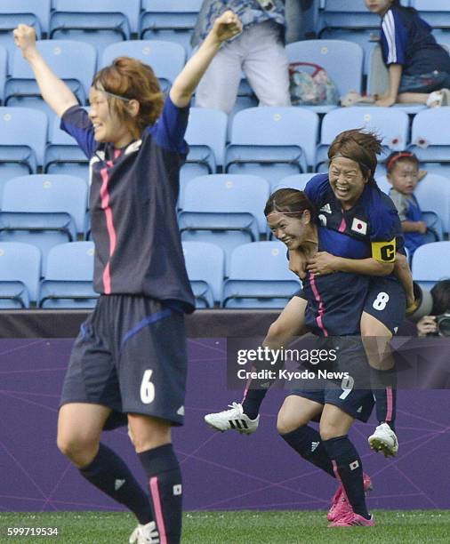 England - Japan's Nahomi Kawasumi celebrates with Japan's captain Aya Miyama after scoring the team's first goal during the first half of an Olympic...