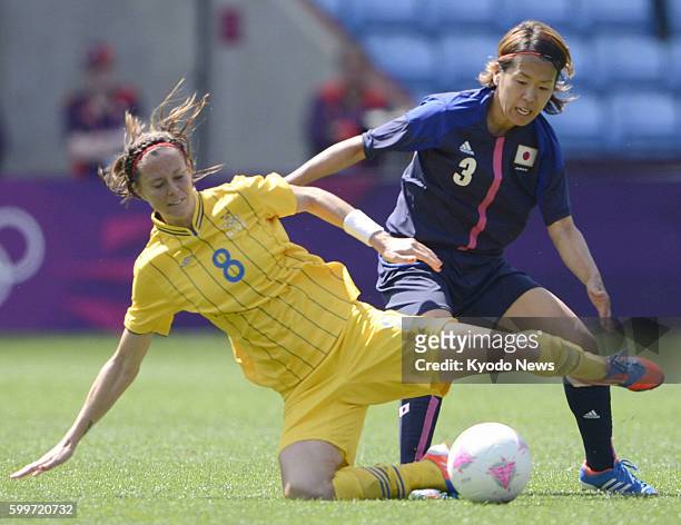 Britain - Japan's Azusa Iwashimizu marks Sweden's Lotta Schelin during the second half of the London Olympics women's soccer Group F match in...