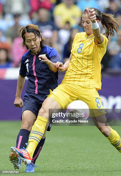 Britain - Japan's Azusa Iwashimizu marks Sweden's Lotta Schelin during the first half of the London Olympics women's soccer Group F match in Coventry...