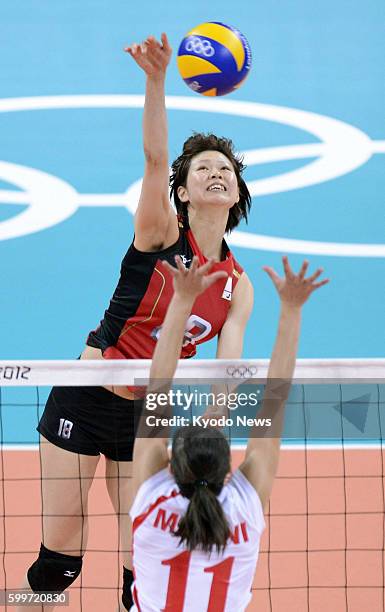 Britain - Japan's Saori Kimura spikes the ball during the first set of a match against Algeria in the women's volleyball tournament at Earls Court at...