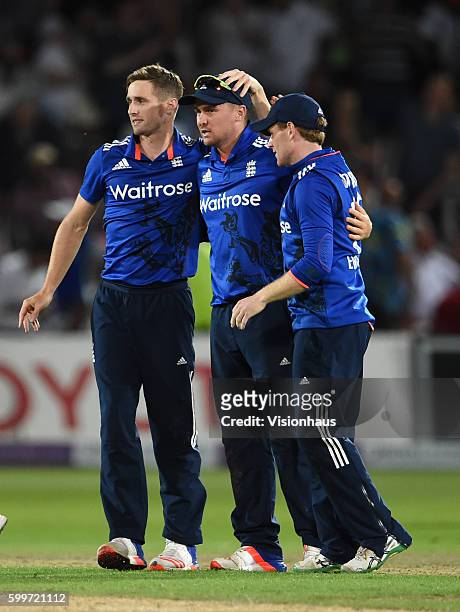 Chris Woakes, Jason Roy and Eoin Morgan celebrate winning the match as Chris Woakes takes the final wicket during the 3rd Royal London ODI between...