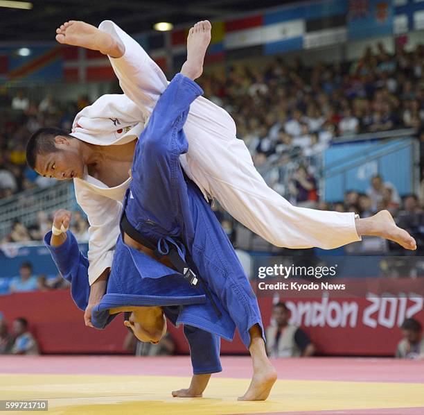 Britain - Japan's Masashi Ebinuma fights South Korea's Cho Jun Ho during the quarterfinals in the men's judo 66-kilogram category at the ExCel venue...