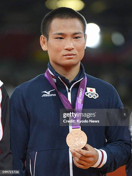 Britain - Japan's Masashi Ebinuma poses with the bronze medal he won in the men's judo 66-kilogram category on July 29, 2012. Ebinuma beat Pawel...