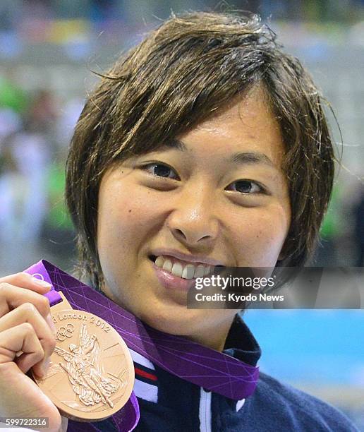 Britain - Japan's Satomi Suzuki shows her bronze medal after finishing third in the women's 100-meter breaststroke at the 2012 London Olympics at...