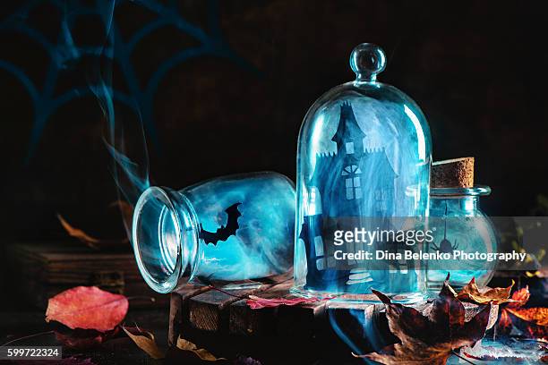 halloween jars with smoke and haunred mansion - halloween craft stock pictures, royalty-free photos & images