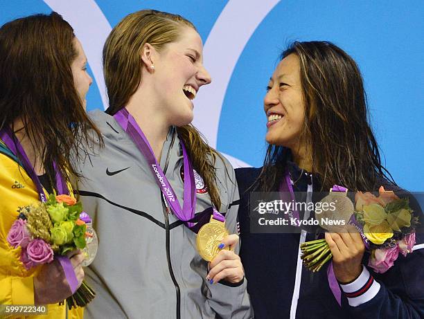 Britain - Japanese bronze medalist Aya Terakawa celebrates with silver medalist Emily Seebohm of Australia and gold medalist Missy Franklin of the...