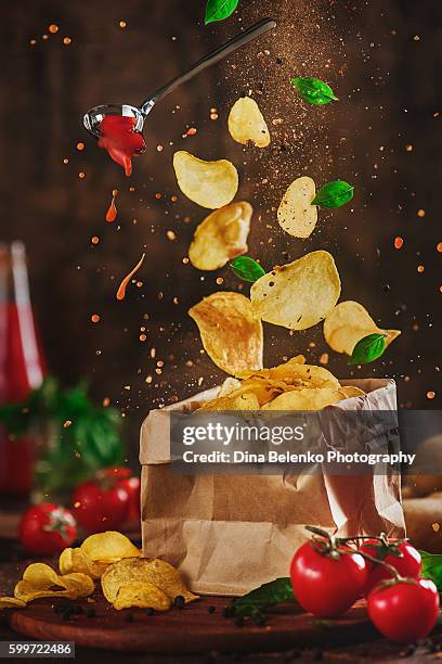 comfort food: flying chips with tomato sauce - bag of chips fotografías e imágenes de stock