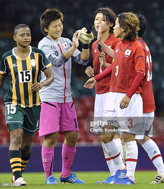Wales - Members of the Japanese team Azusa Iwashimizu , Saki Kumagai and goalkeeper Ayumi Kaihori exchange high-fives after holding South Africa to a...