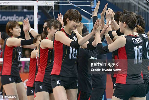 Britain - Japan's Saori Kimura celebrates with her teammates after beating the Dominican Republic in the Olympic women's volleyball tournament at...