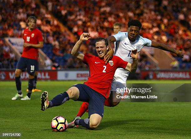 Kristoffer Haraldseid of Norway is tackled by Chuba Akpom of England during the European Under 21 Qualifier match between England U21 V Norway U21 at...