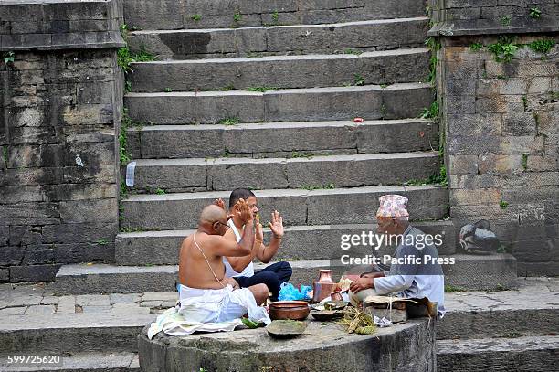 Priest offering ritual prayer at the Bank of Bagmati River of Pashupatinath Temple during Rishi Panchami Festival celebrations at Pashupatinath...