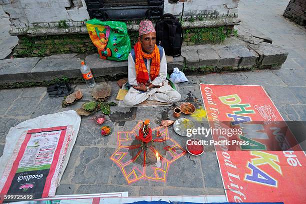 Priest awaits for the devotees to offering ritual prayer at the Bank of Bagmati River of Pashupatinath Temple during Rishi Panchami Festival...