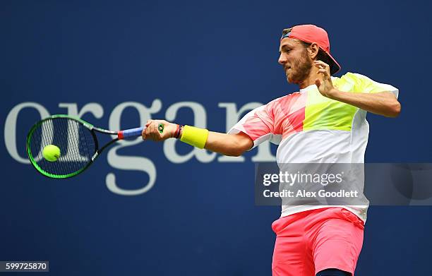 Lucas Pouille of France returns a shot to Gael Monfils of France during their Men's Singles Quarterfinal Match on Day Nine of the 2016 US Open at the...