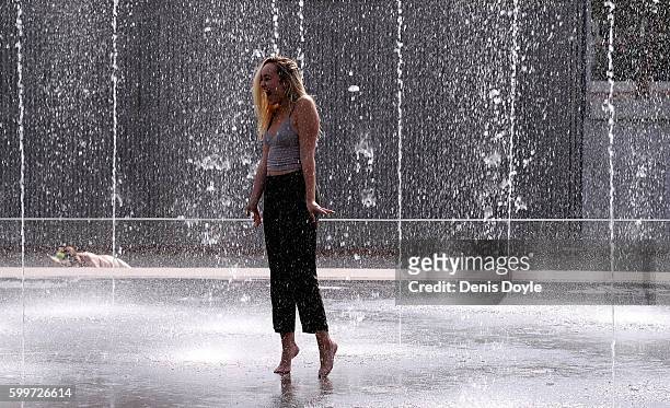 Girl cools down in a fountain in the Madrid Rio playground on September 5, 2016 in Madrid, Spain. A three-day heatwave has hit central and southern...