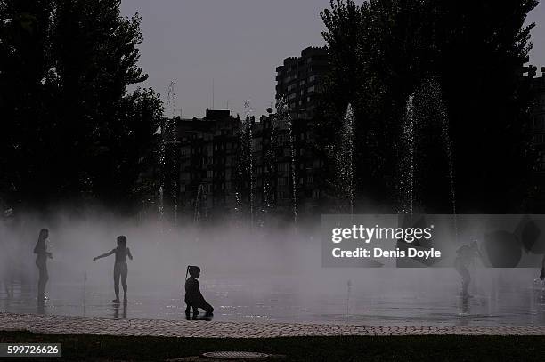 Children cool down in a fountain in the Madrid Rio playground on September 5, 2016 in Madrid, Spain. A three-day heatwave has hit central and...