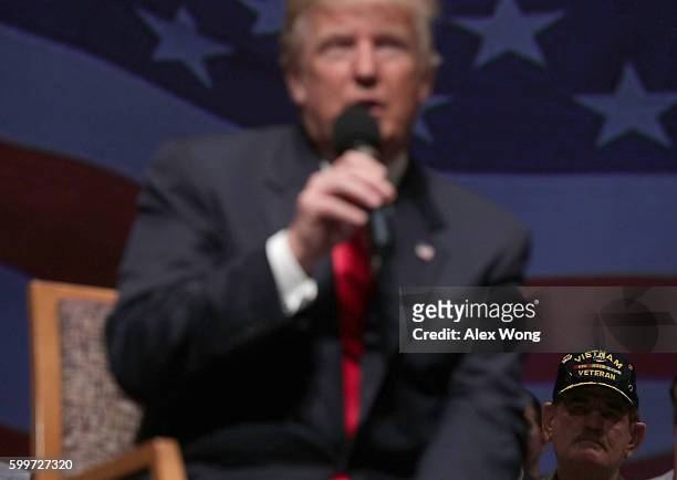 Veteran listens as Republican presidential nominee Donald Trump speaks during a campaign event September 6, 2016 in Virginia Beach, Virginia. Trump...