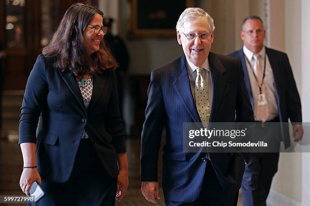 Senate Majority Leader Mitch McConnell walks back to his office with Senate Republican Secretary Laura Dove at the U.S. Capitol September 6, 2016 in...