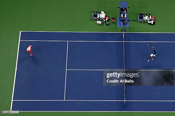 Gael Monfils of France returns a shot to Lucas Pouille of France during their Men's Singles Quarterfinal Match on Day Nine of the 2016 US Open at the...