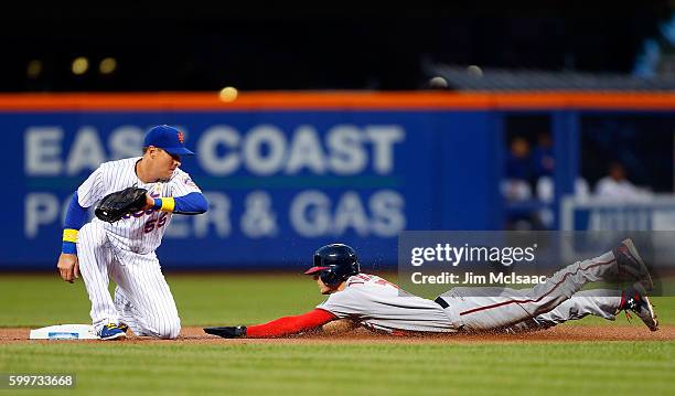 Trea Turner of the Washington Nationals in action against Kelly Johnson of the New York Mets at Citi Field on September 2, 2016 in the Flushing...