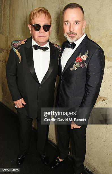 Sir Elton John and David Furnish pose backstage at the GQ Men Of The Year Awards 2016 at the Tate Modern on September 6, 2016 in London, England.